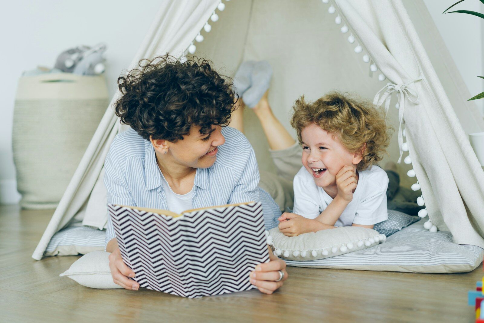 Photo by Vitaly Gariev a woman reading a book to a child