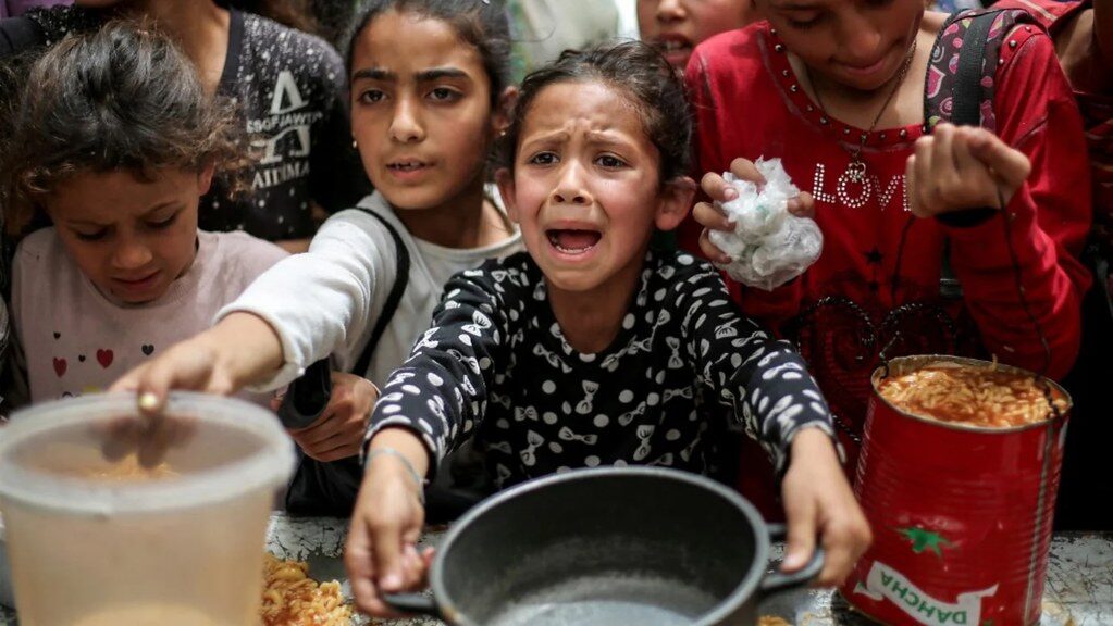 Distribuição de ajuda alimentar em Nuseirat, na Faixa de Gaza, em abril de 2025. Foto: Eyad Baba/AFP. Fonte: Flickr/coolloud. Licença: CC BY-NC-ND 2.0. Ajuda alimentar em Nuseirat, Faixa de Gaza, abril de 2025. Foto: Eyad Baba/AFP, via Flickr/coolloud. CC BY-NC-ND 2.0.